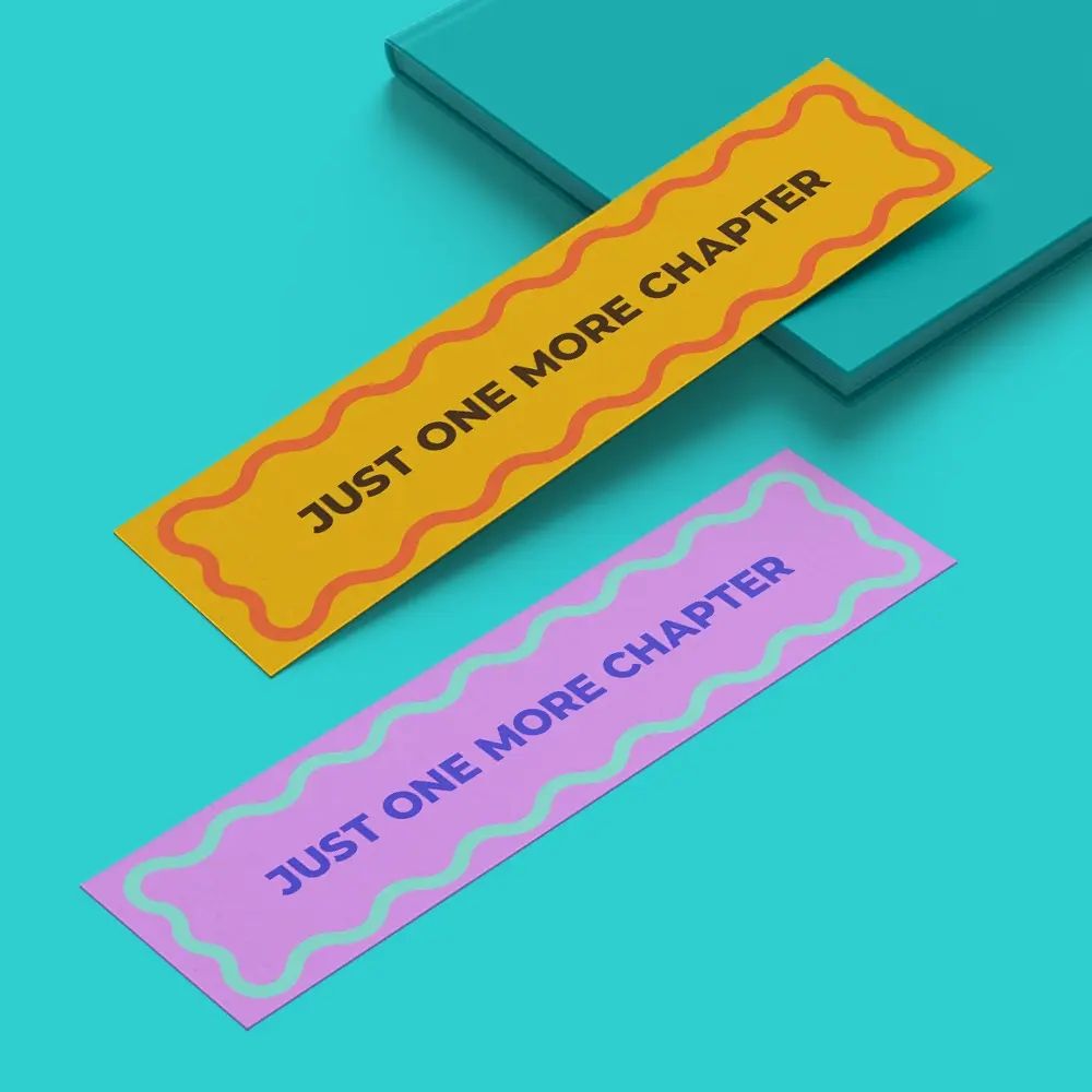 Two Bookmarks, one purple, one orange, both reading "just one more chapter" 