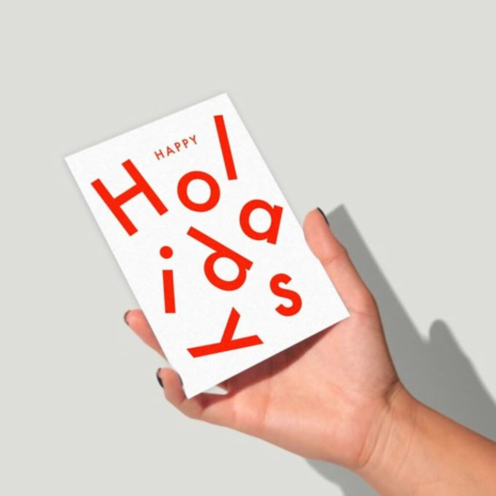 A white and red 'happy holidays' card