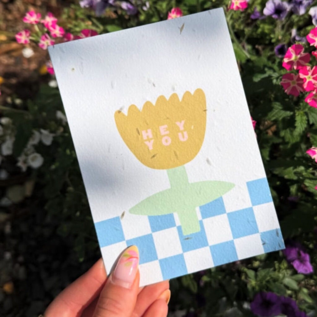 seed paper card with blue and white cheque and a yellow and green illustrated flower