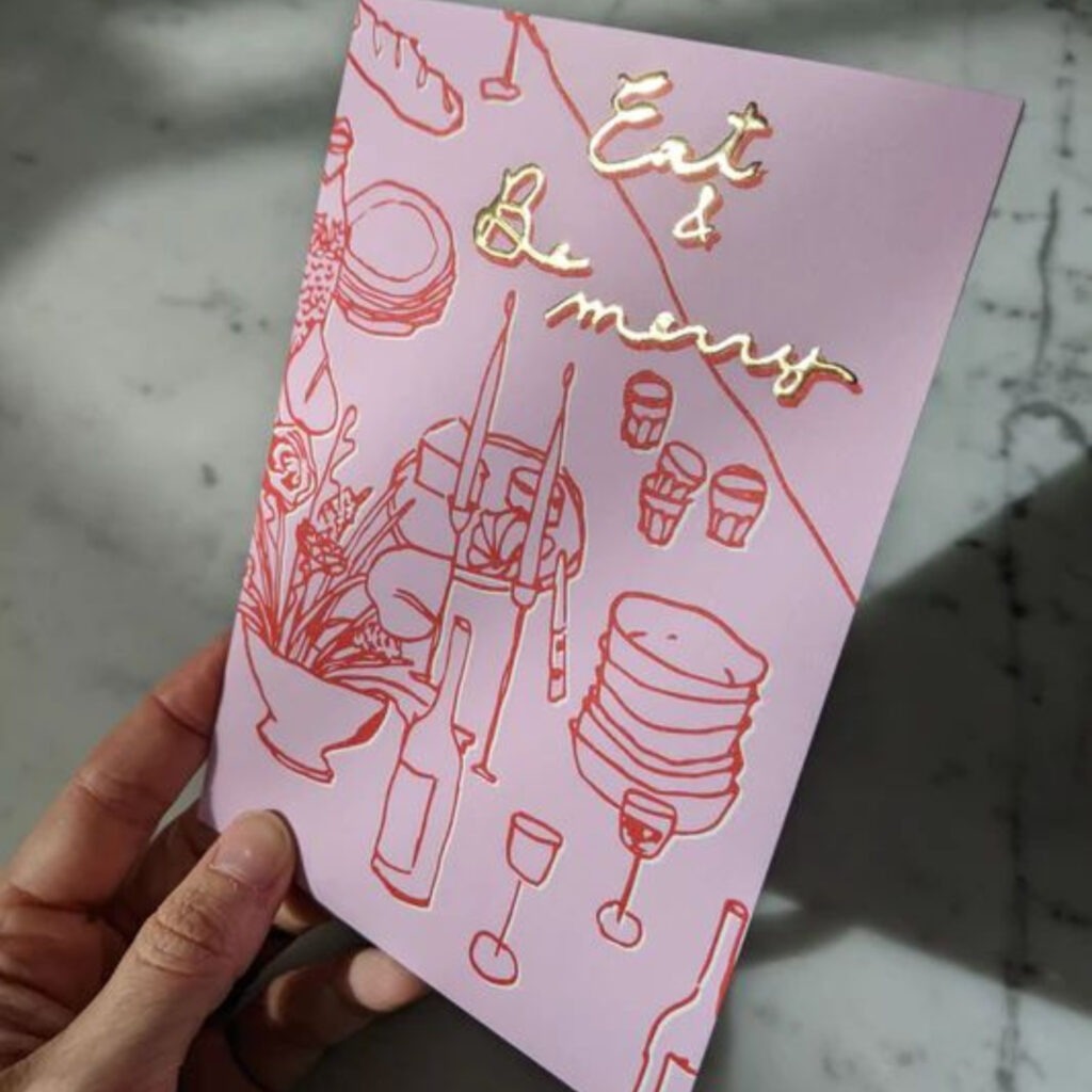 pink card with fine line illustrations and gold foiled text