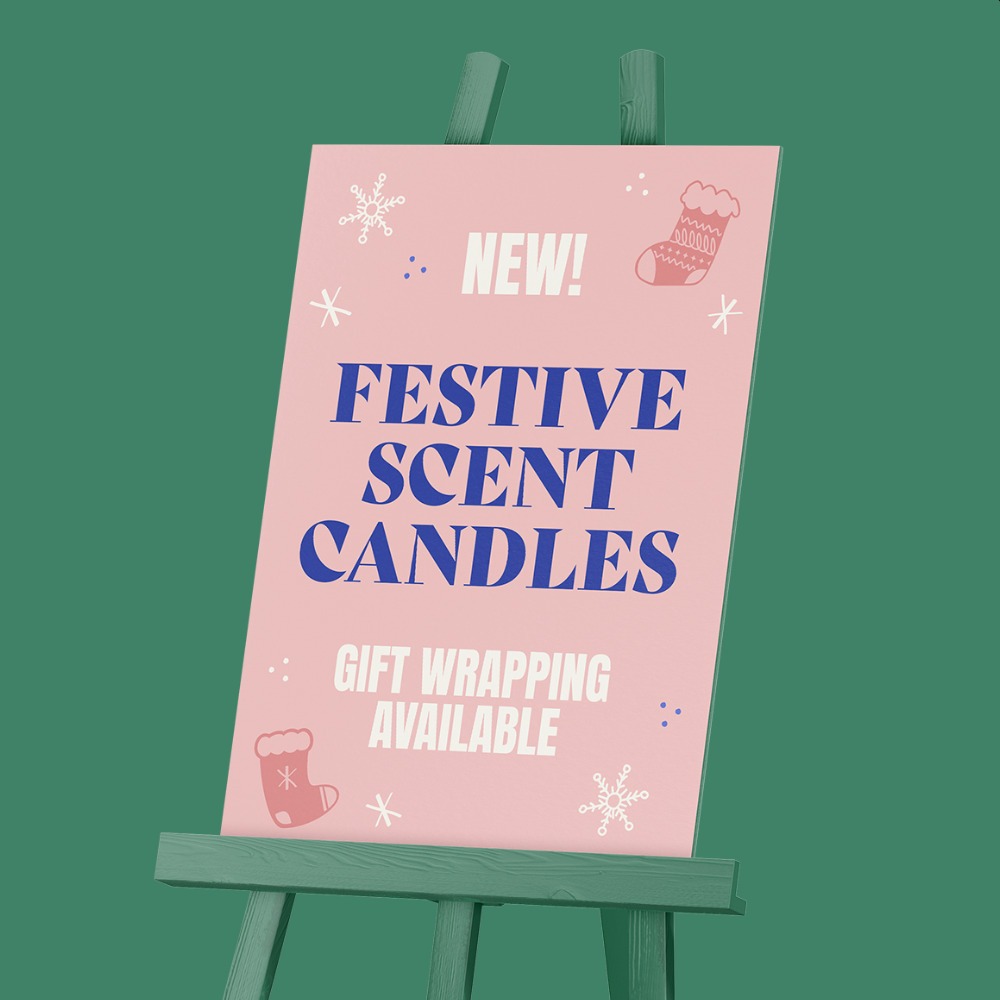 Christmas Display Board reading "New Festive Scent Candles - Gift Wrapping Available"