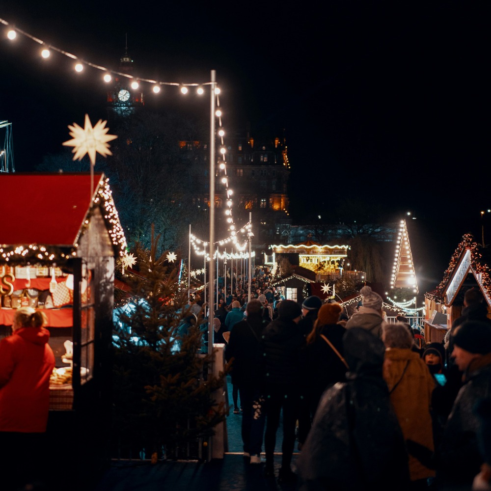 Customers enjoying the lights and festivities at ab outdoor Christmas Market