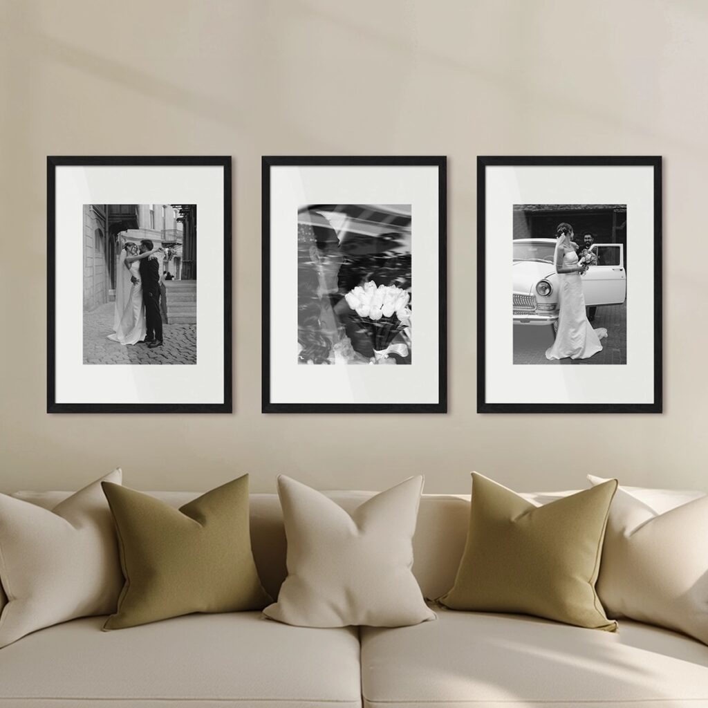 Three framed wedding prints on a beige coloured wall, all in black frames.
