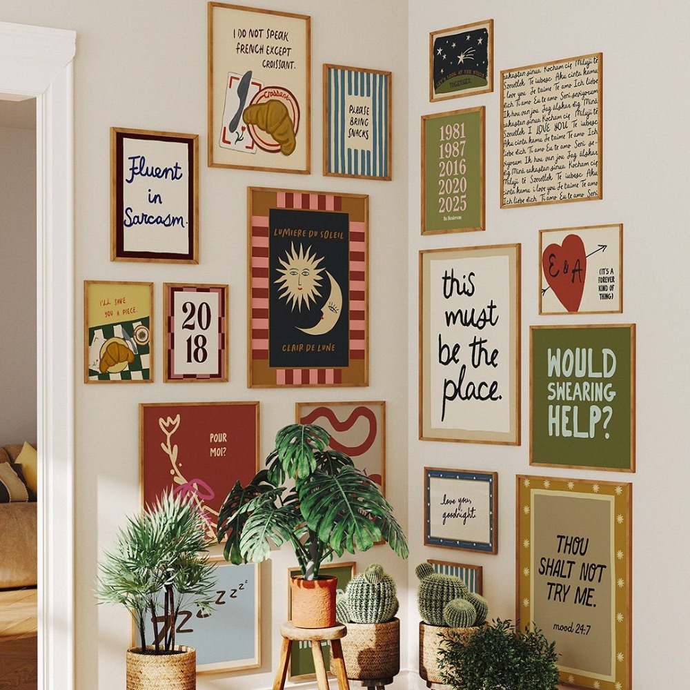 An eclectic gallery wall featuring different artworks and prints in various frames.