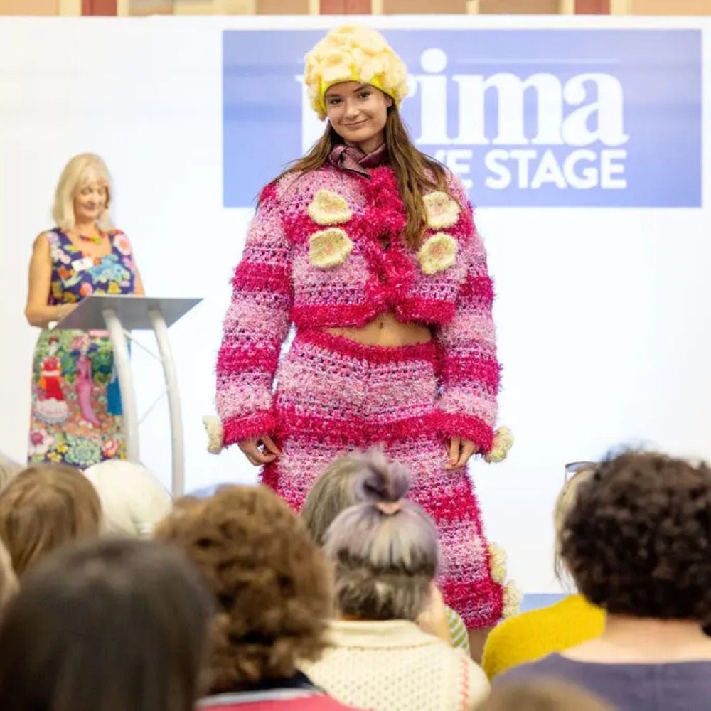 A model on the catwalk wearing a handcrafted outfit at the Knit and Stitch Show.
