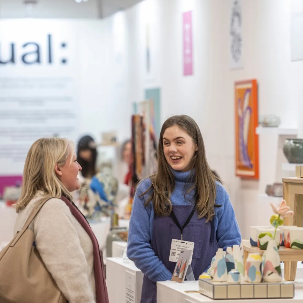 Two women around a trade stall at Top Drawer, London.
