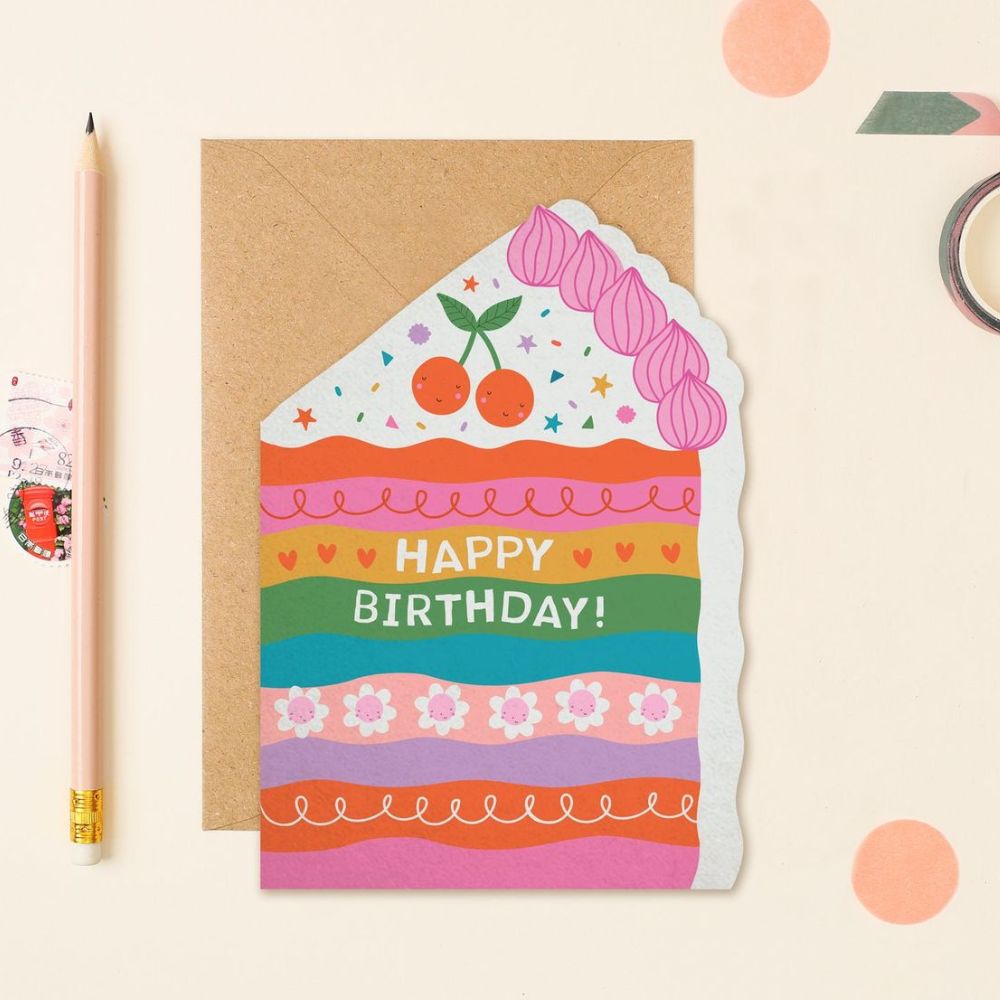Shaped card resembling a colourful slice of cake with decorative layers and the text “Happy Birthday!”