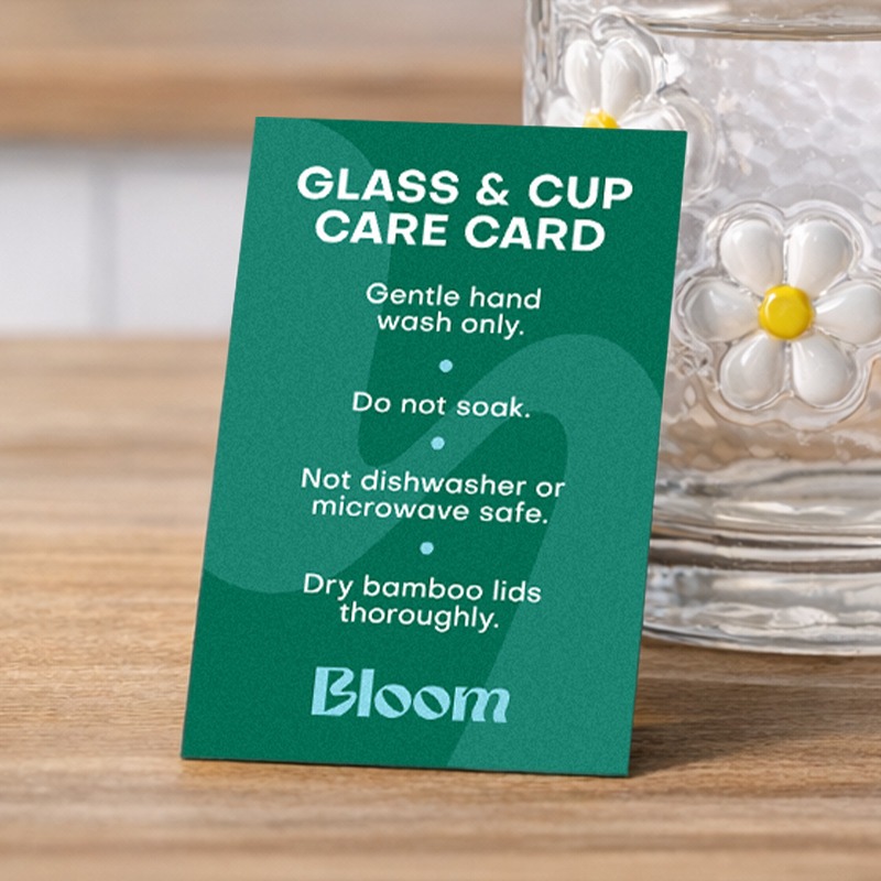 A green card with care instructions for a glassware product. 
