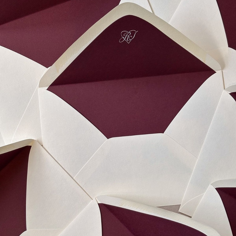 Burgundy envelope liners in off-white envelopes. 