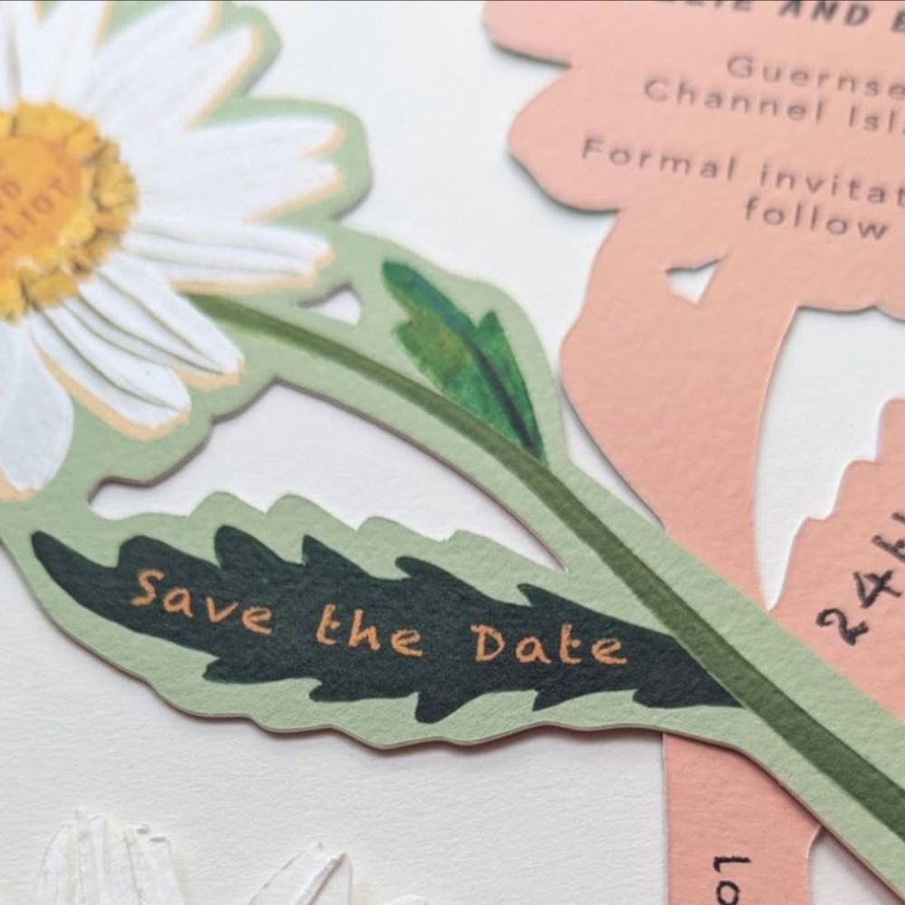 A bespoke Save the Date in the shape of a daisy. 