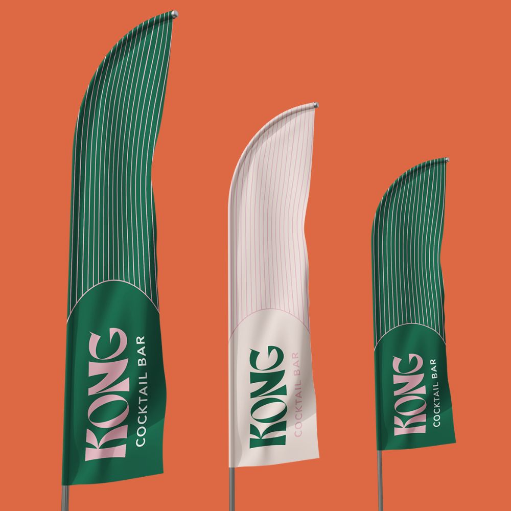 Three feather flags with different designs, two green and one white