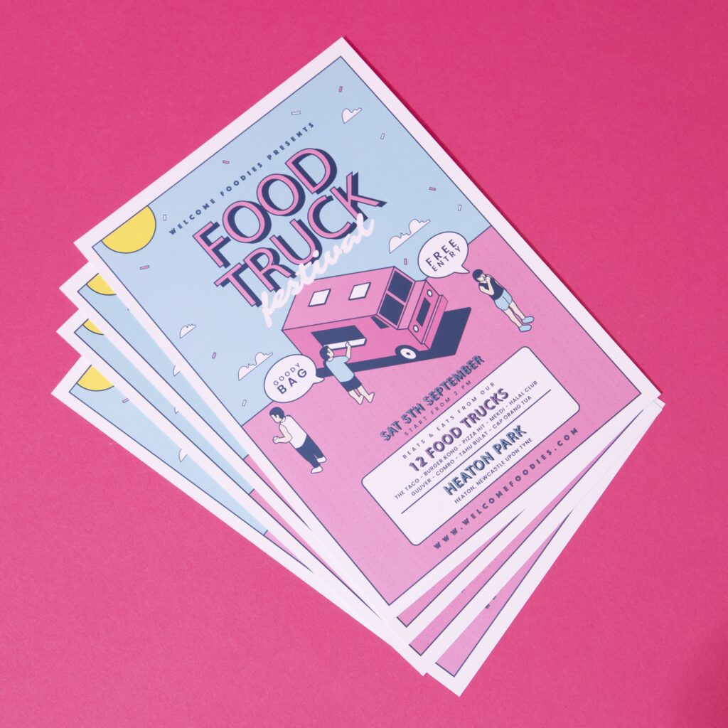 A pile of colourful Leaflets for a food truck festival against a bright pink backdrop.