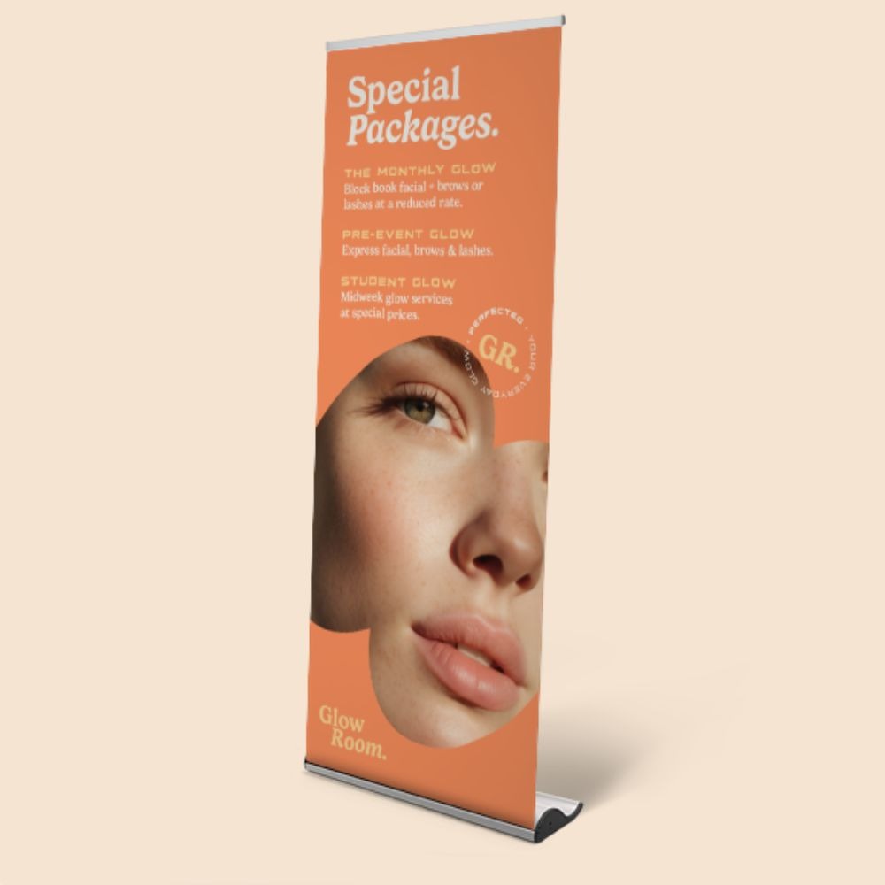 A Roller Banner advertising Glow Room's Special Beauty Packages - The Monthly Glow, Pre-Event Glow, and Student Glow. 