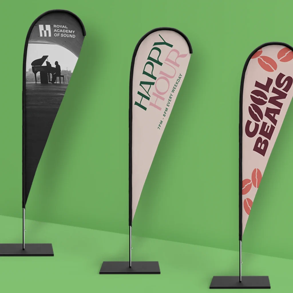 Three Flags with different designs. From left to right, they're advertising the Royal Academy of Sound, Happy Hour, and Cool Beans.