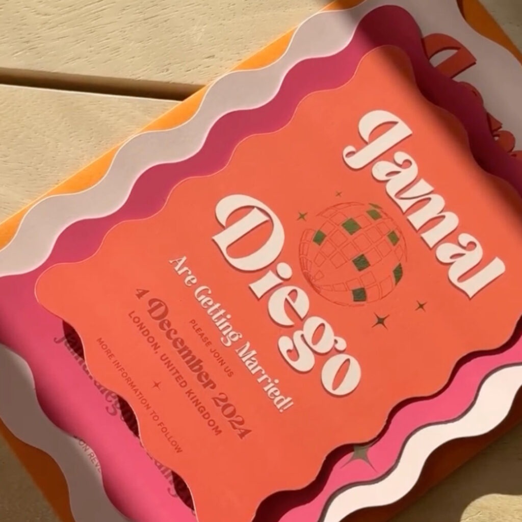A retro-style wedding invitation for Jamal and Diego, featuring a series of stacked cards with wavy, scalloped edges in shades of orange, pink, and white. The top orange card displays a disco ball illustration and the date "4 December 2024" in London, United Kingdom, using bold, vintage-inspired typography.