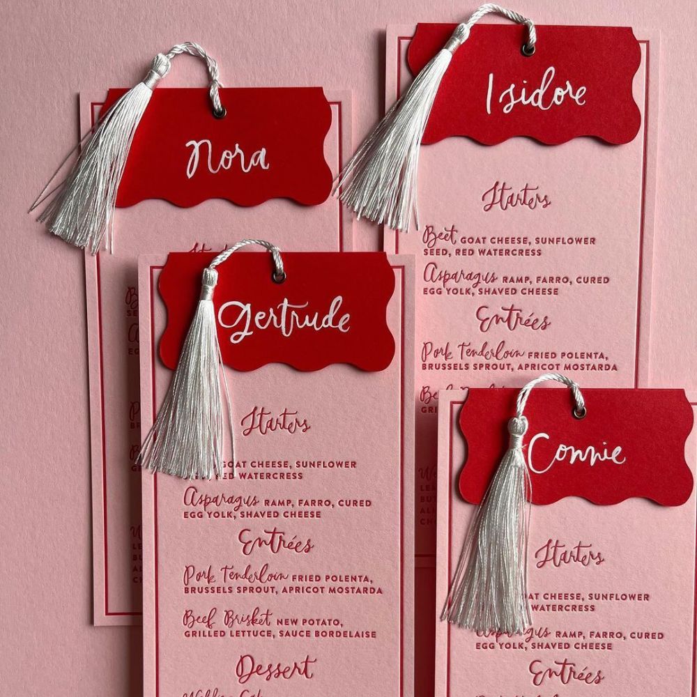 Pink Wedding Menus with guest's names attached. 