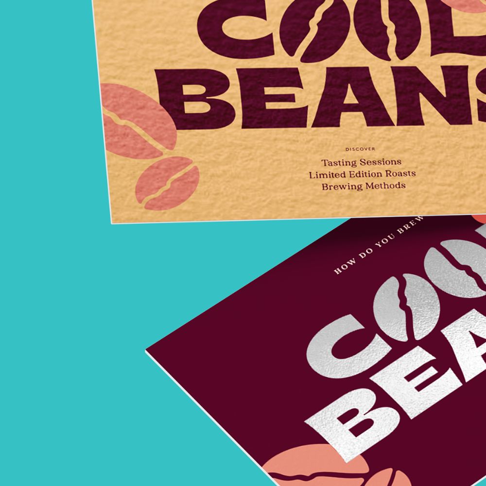 Two business cards each saying "Cool Beans" - with coffee beans for the O's. The top one is a brown colour, the bottom one is burgundy.