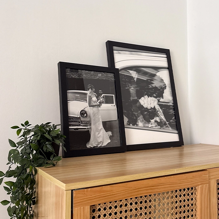 Two Wedding Framed Prints side by side on a wooden sideboard. 