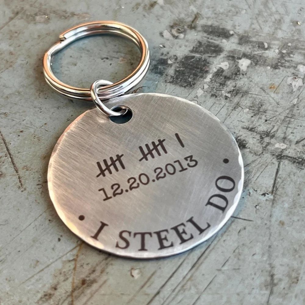 A steel keyring with black writing reading "12.20.2013 - I steel do"