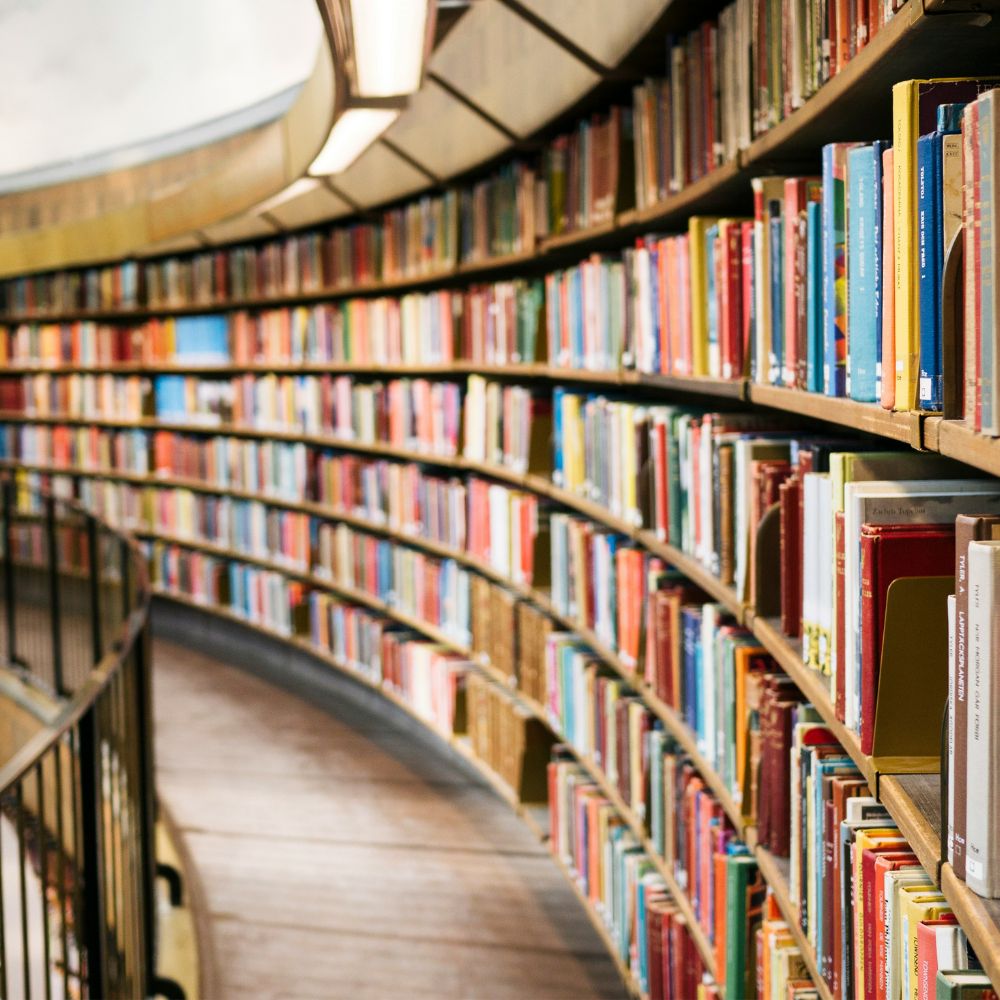 A large, curved library shelf full of books. 