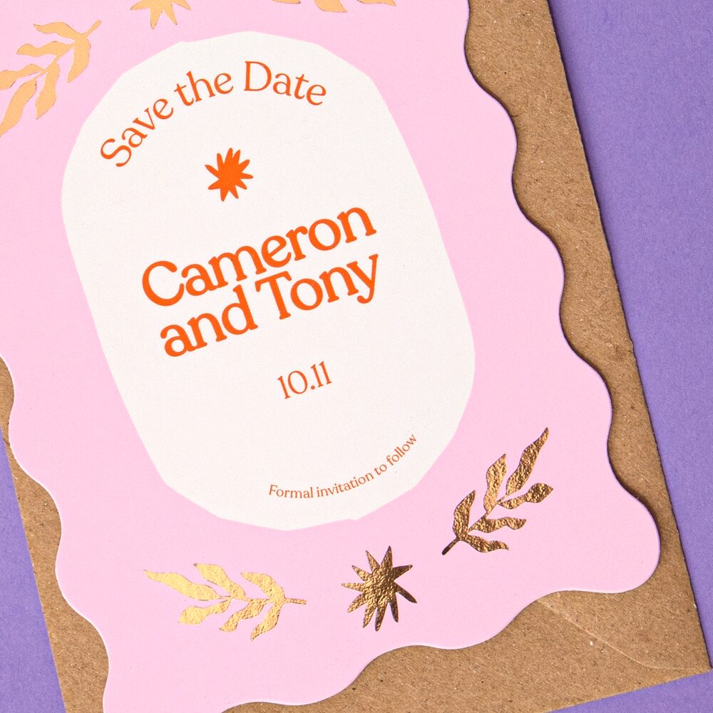 Cameron and Tony's Save the Dates, featuring gold foiling.