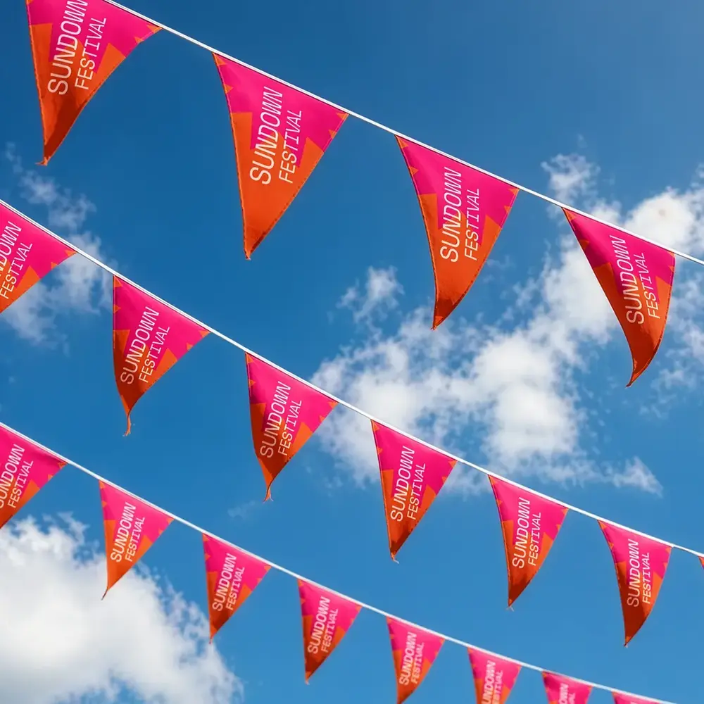 Bunting for Sundown Festival, photographed against a blue sky.