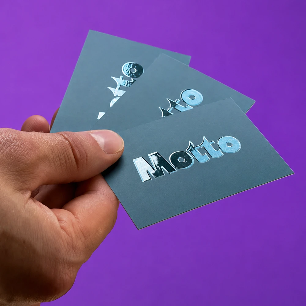 A hand holding three Business Cards in front of a purple background.