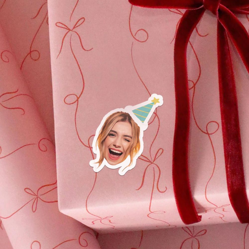 A custom photo Sticker attached to a gift wrapped present. 