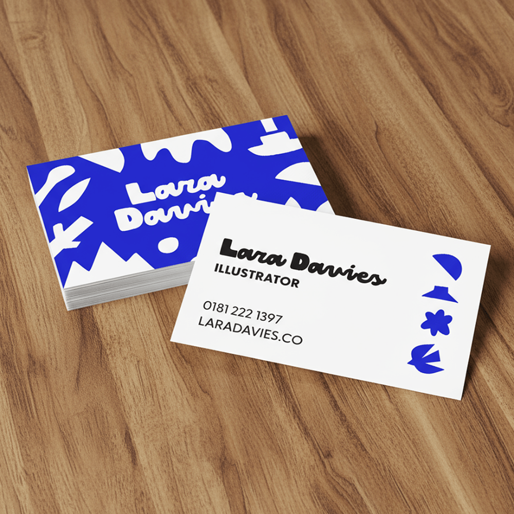 A blue and white flowery business card with 'Lara Davies - Illustrator' printed on it