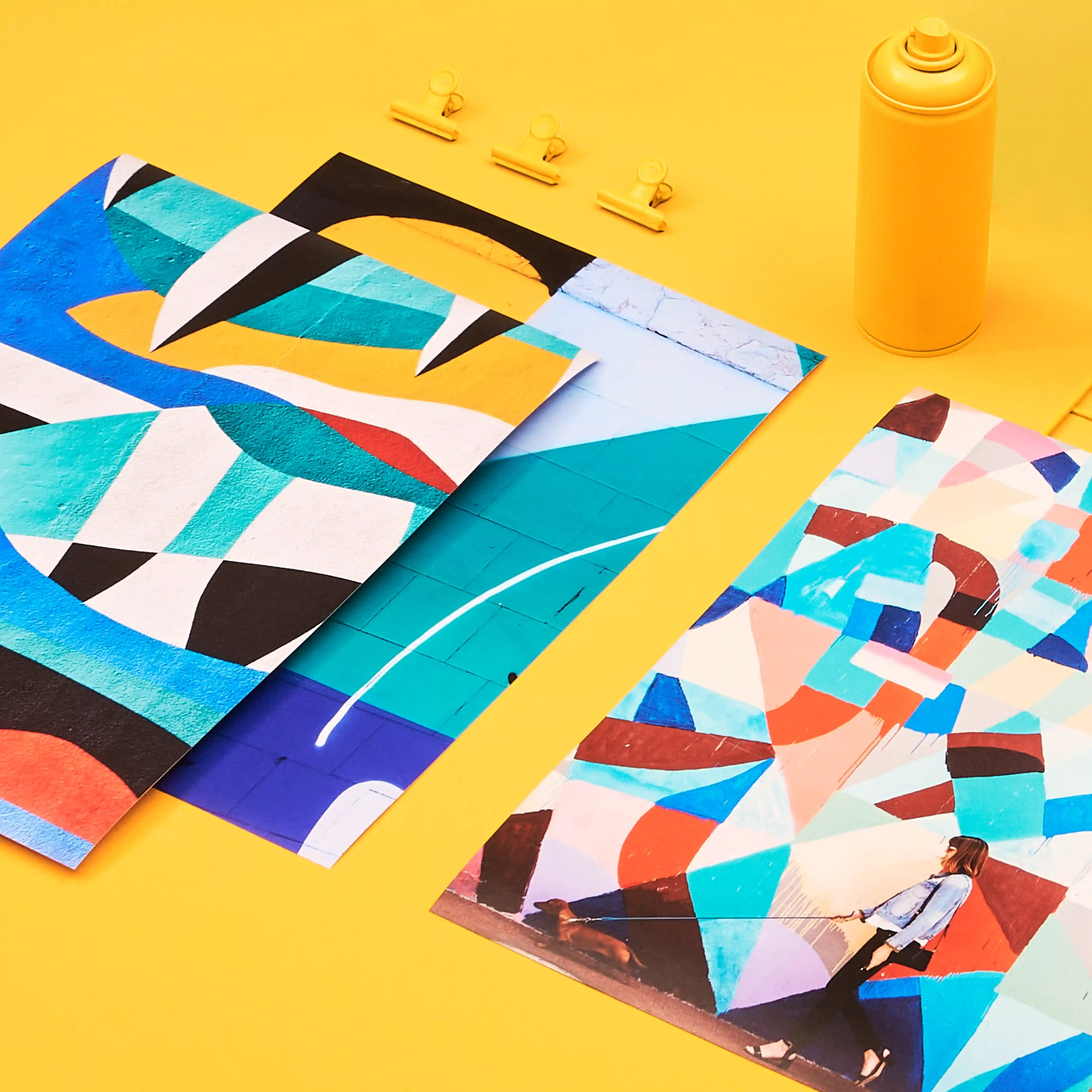 A selection of Giclée Prints photographed on a yellow background.
