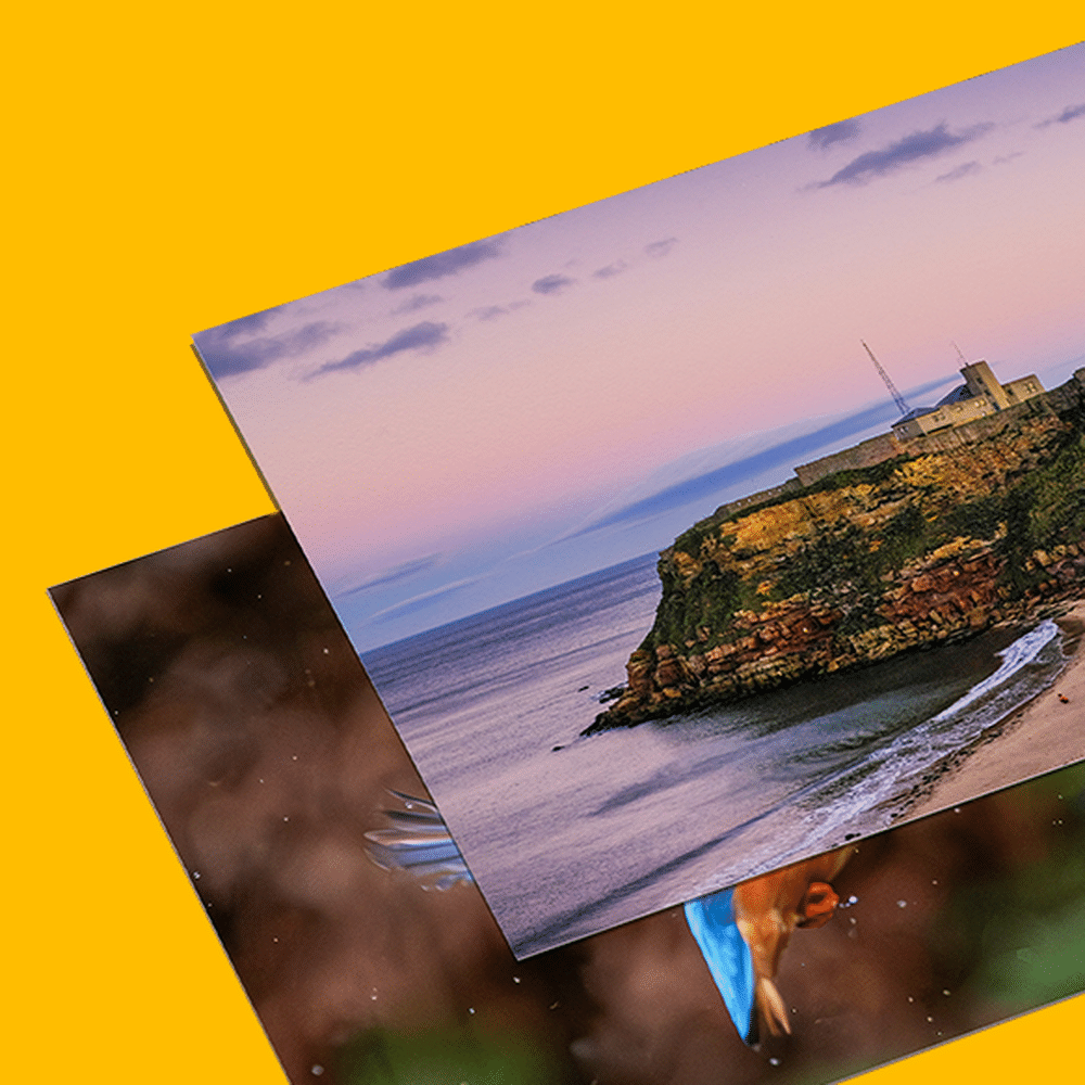 Two Photography Prints on top of each other on a yellow background, The top one is a landscape shot of a cliff and beach.