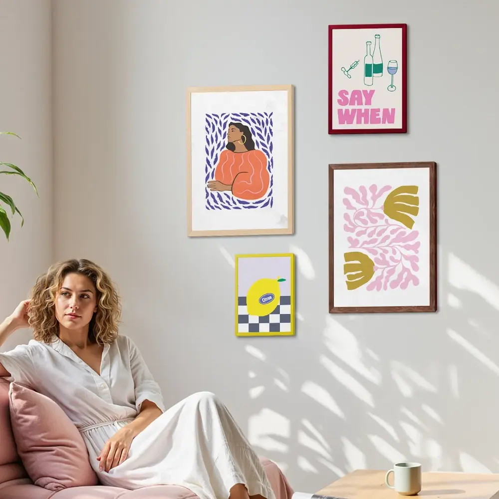 A woman sat in front of a gallery wall of Framed Prints.