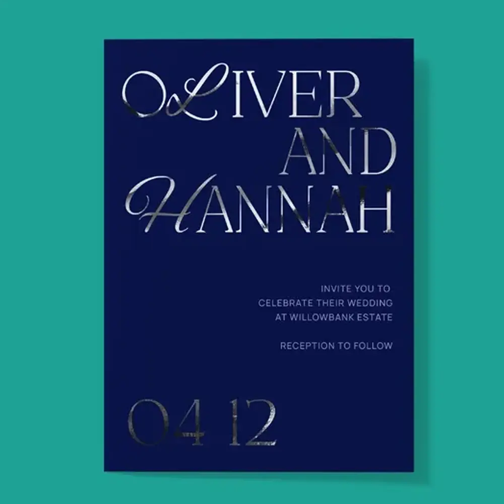 A dark blue Wedding Invitation with silver foiled lettering.