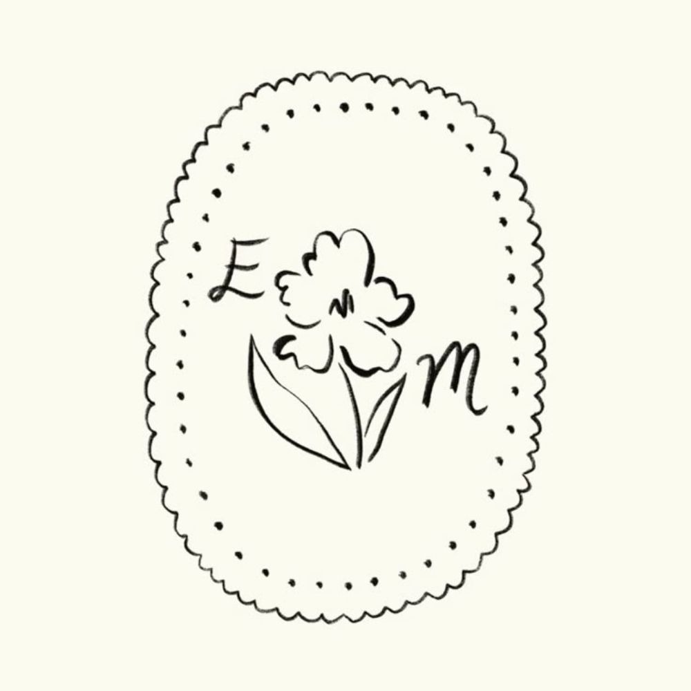 An illustrated wedding monogram featuring letters E and M, with a flower motif and border.