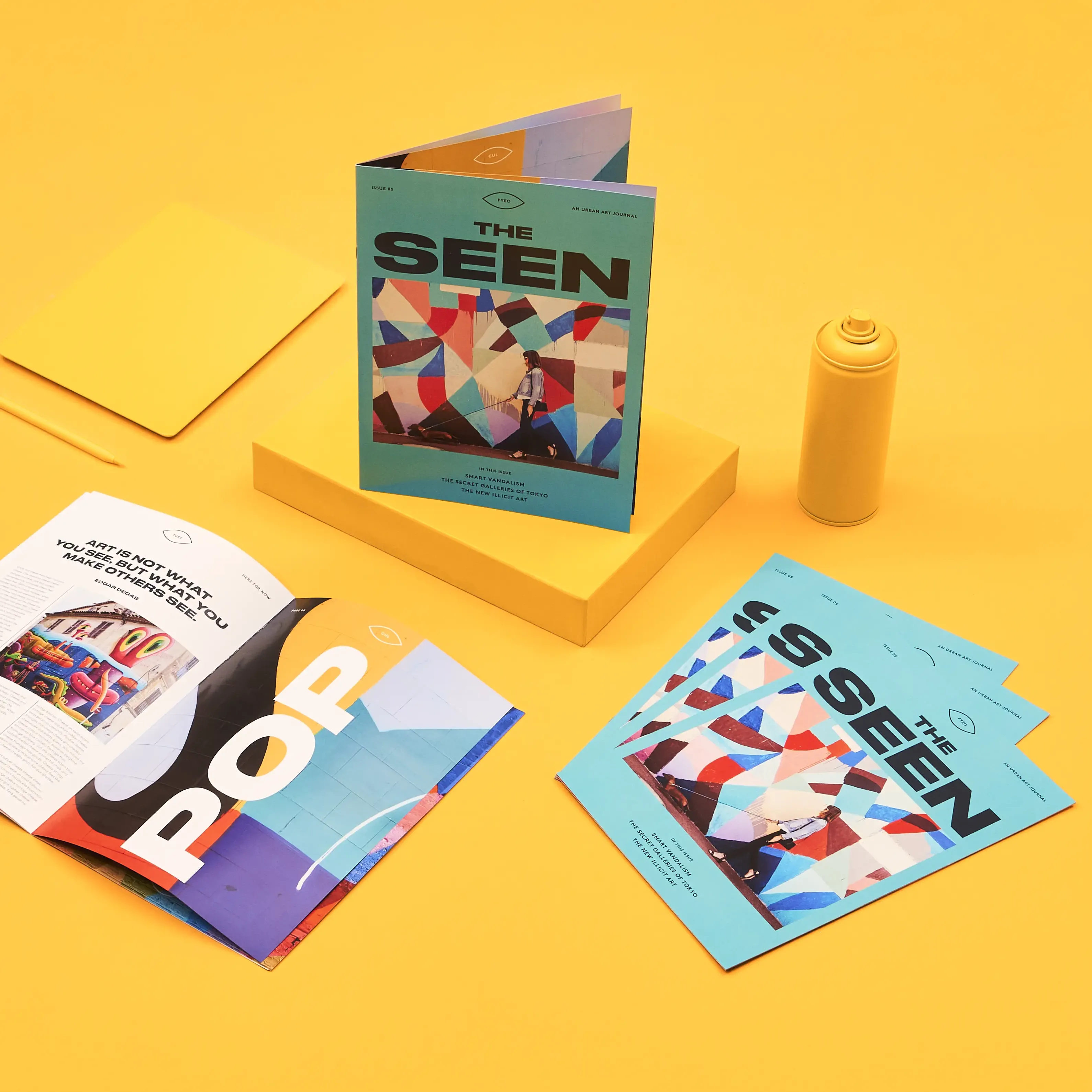 Colorful saddle-stitched brochures displayed against a yellow background