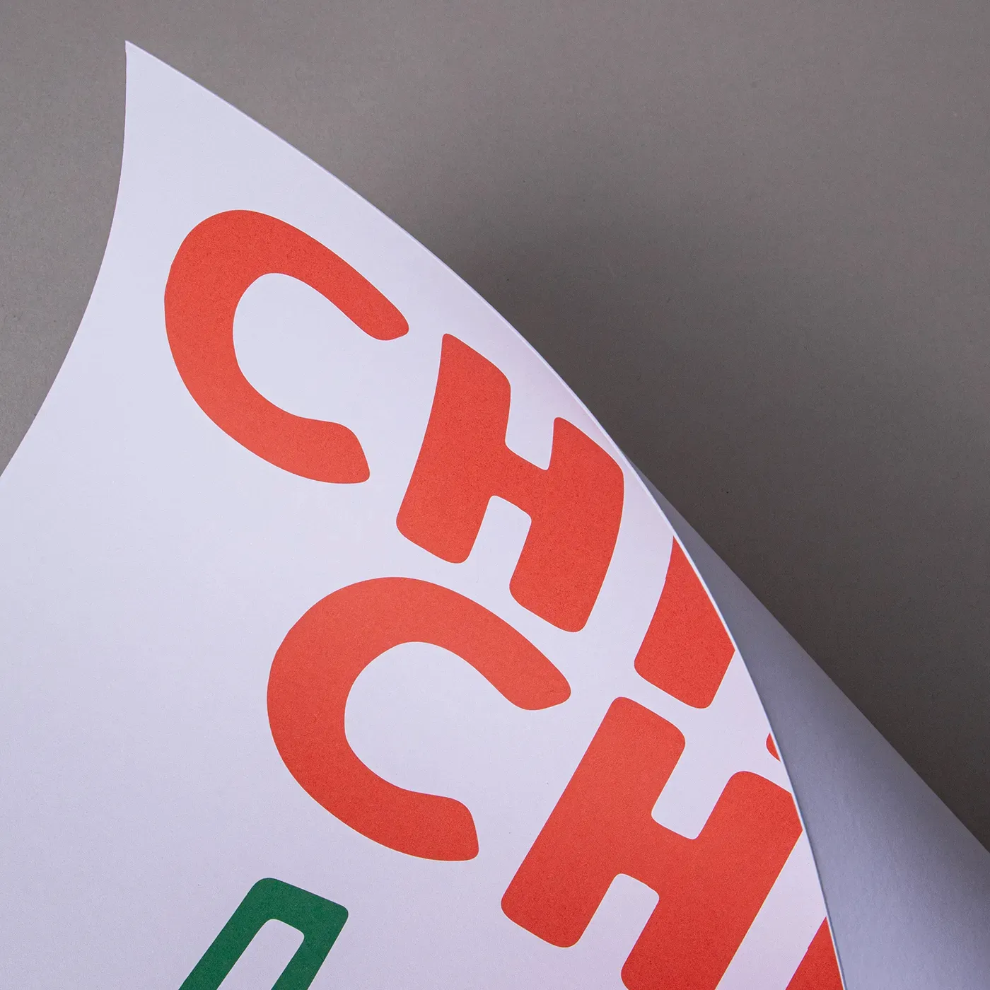 White card with a simple red text design, curved to show slight texture.