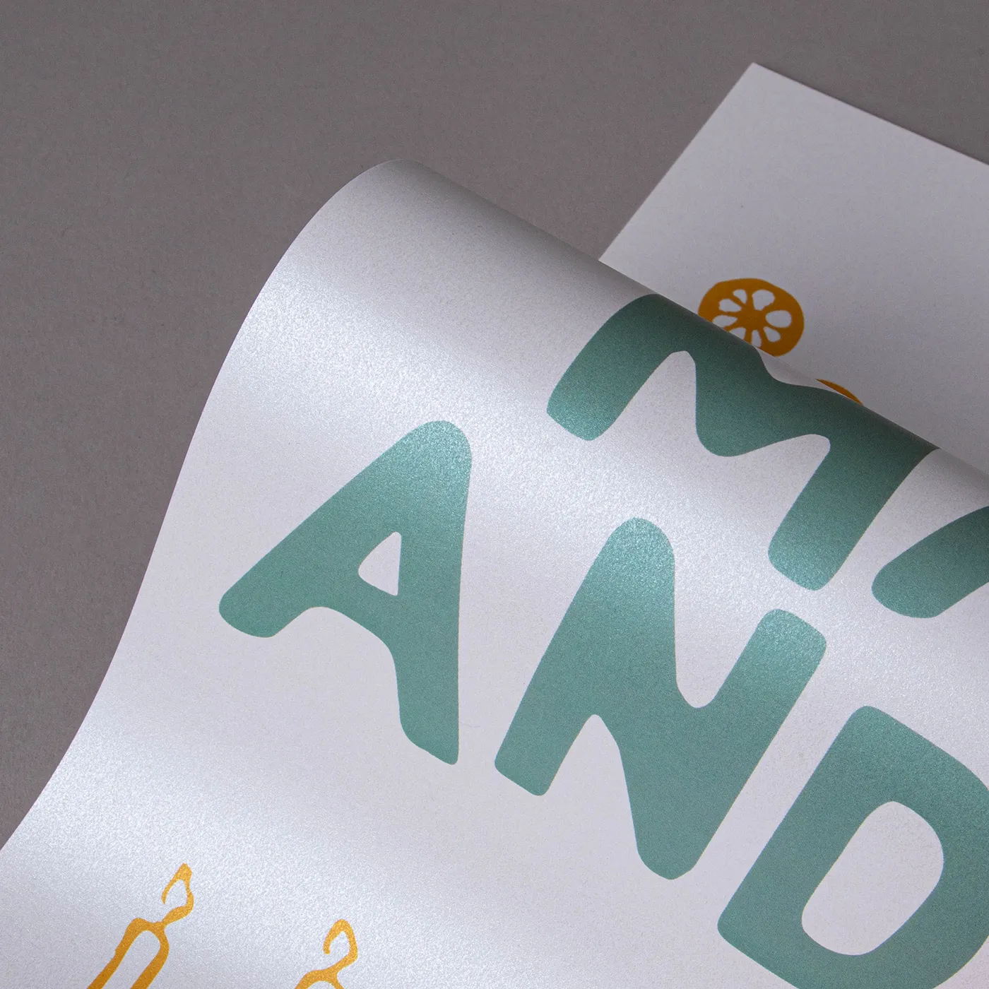 Close up image of Pearlescent paper printed with green text and positioned in a wave, demonstrating the shine.