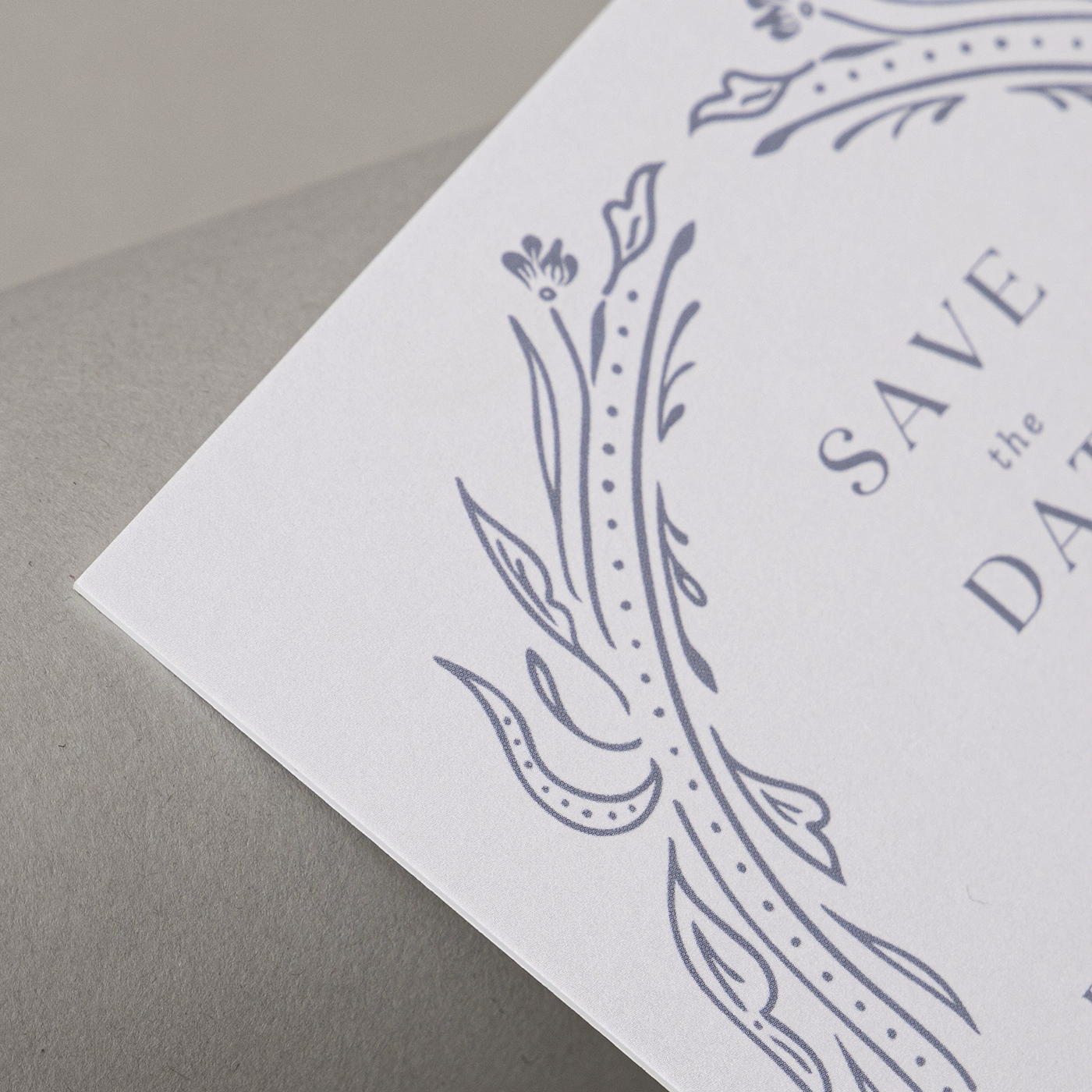 Close up image of white triple thick smooth paper printed with a delicate blue design.