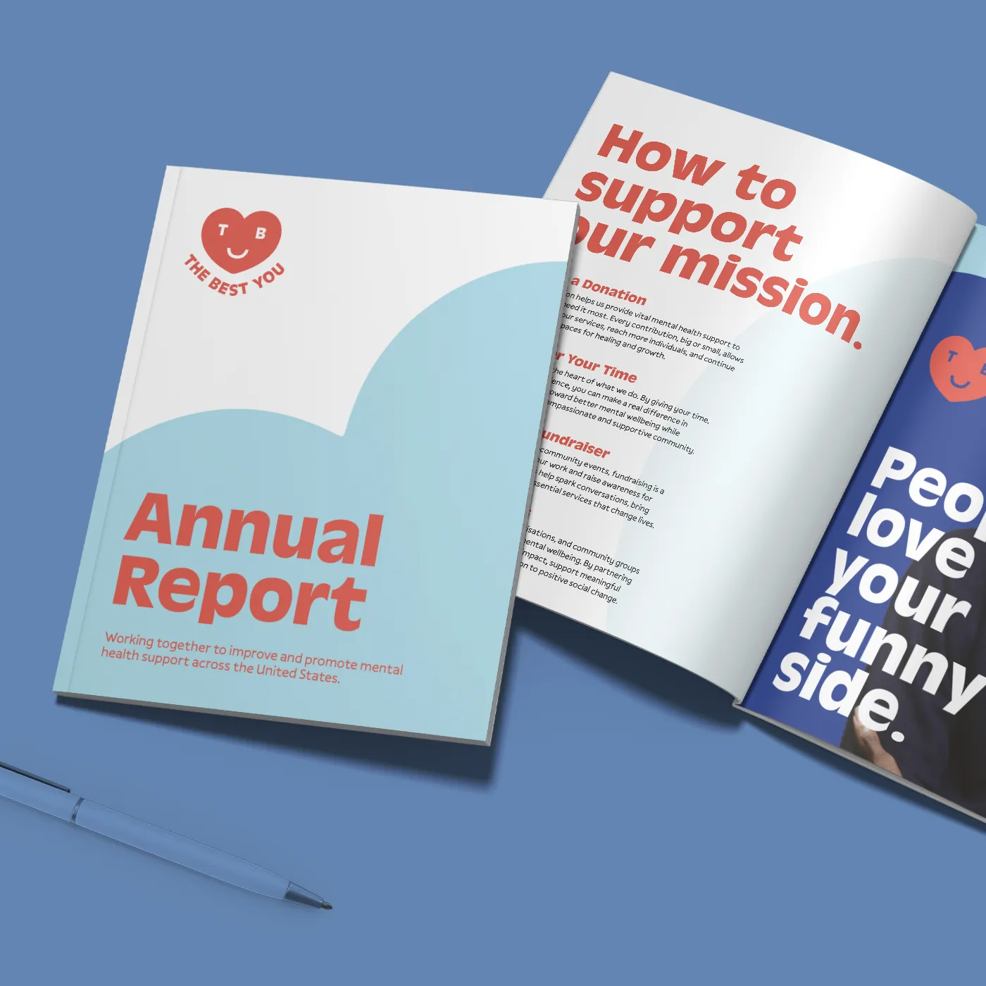 One "Annual Report" booklet is shown closed, while another next to it is open to a page titled "How to support our mission," both set against a blue background with a matching blue pen in the foreground.