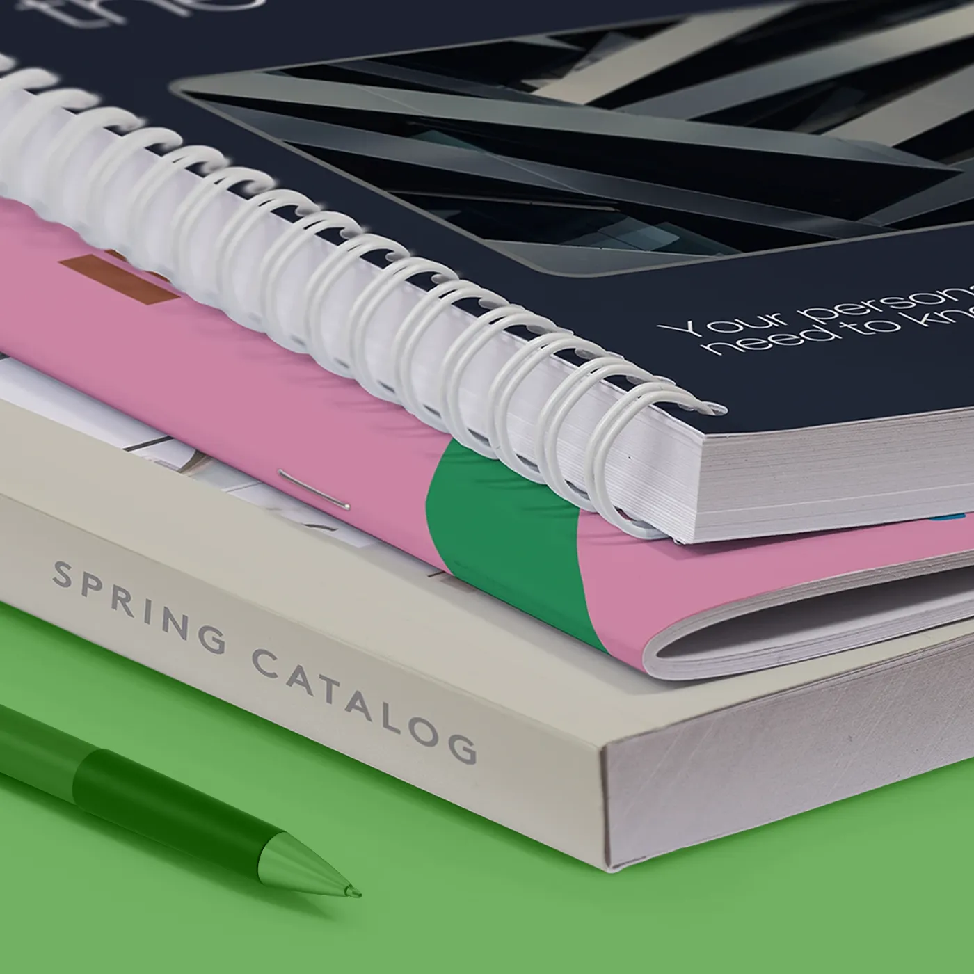 Three stacked Catalogs showing various binding types - perfect bound, saddle stitch, and spiral bound
