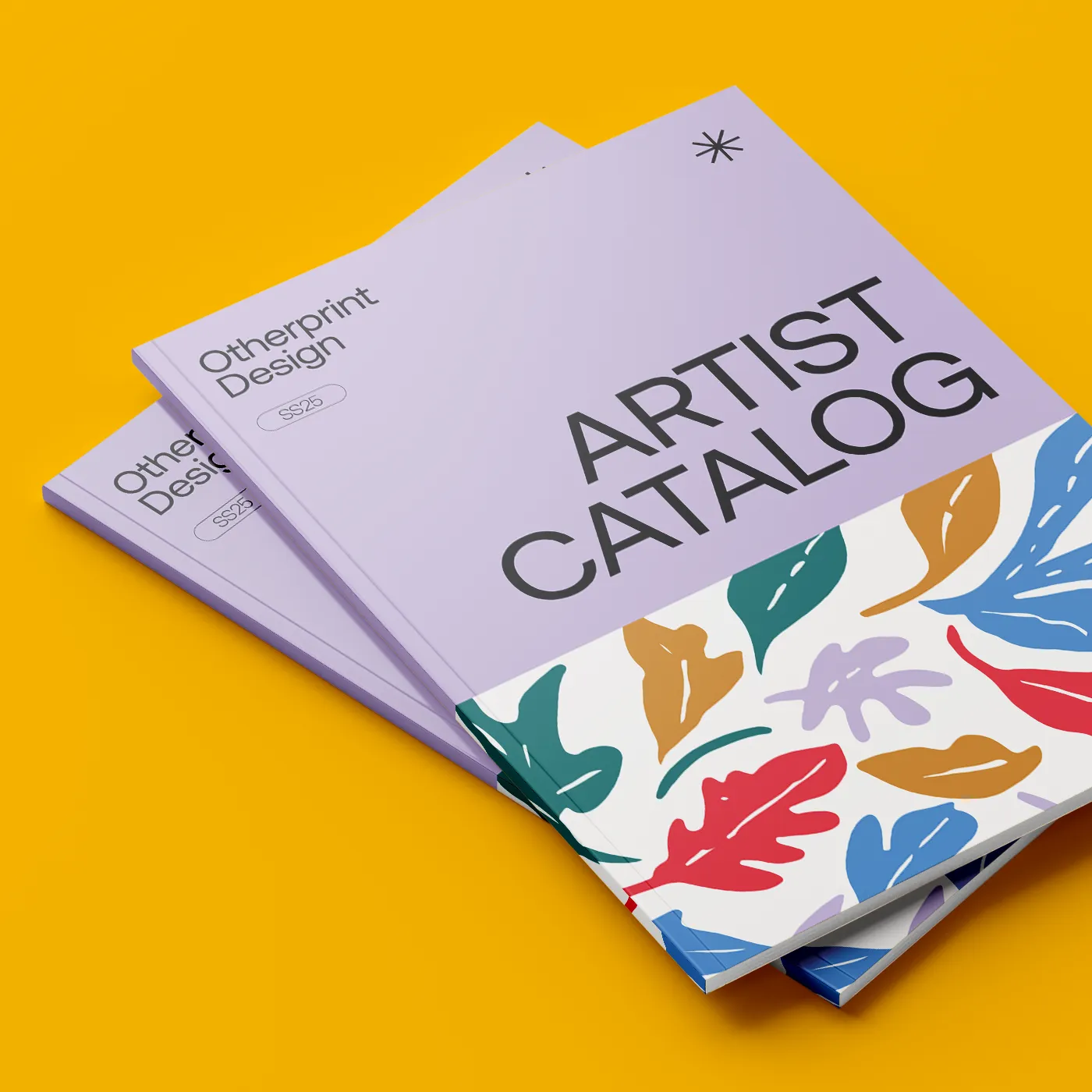 Two copies of a perfect-bound "ARTIST CATALOG" for Otherprint Design's SS25 collection are stacked on a bright yellow background. The catalog covers are light purple on top with a colorful, bold leaf pattern across the bottom half.