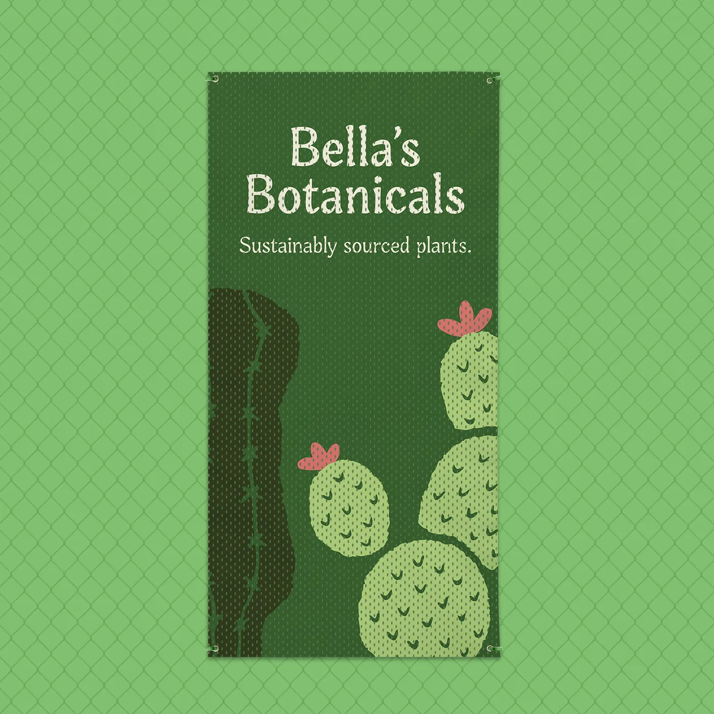 A vertical version of the "Bella's Botanicals" mesh banner hangs against a green chain-link fence. The design features the same dark green background, cacti illustrations, and ivory text as the horizontal version. Metal grommets are visible at the four corners for hanging.