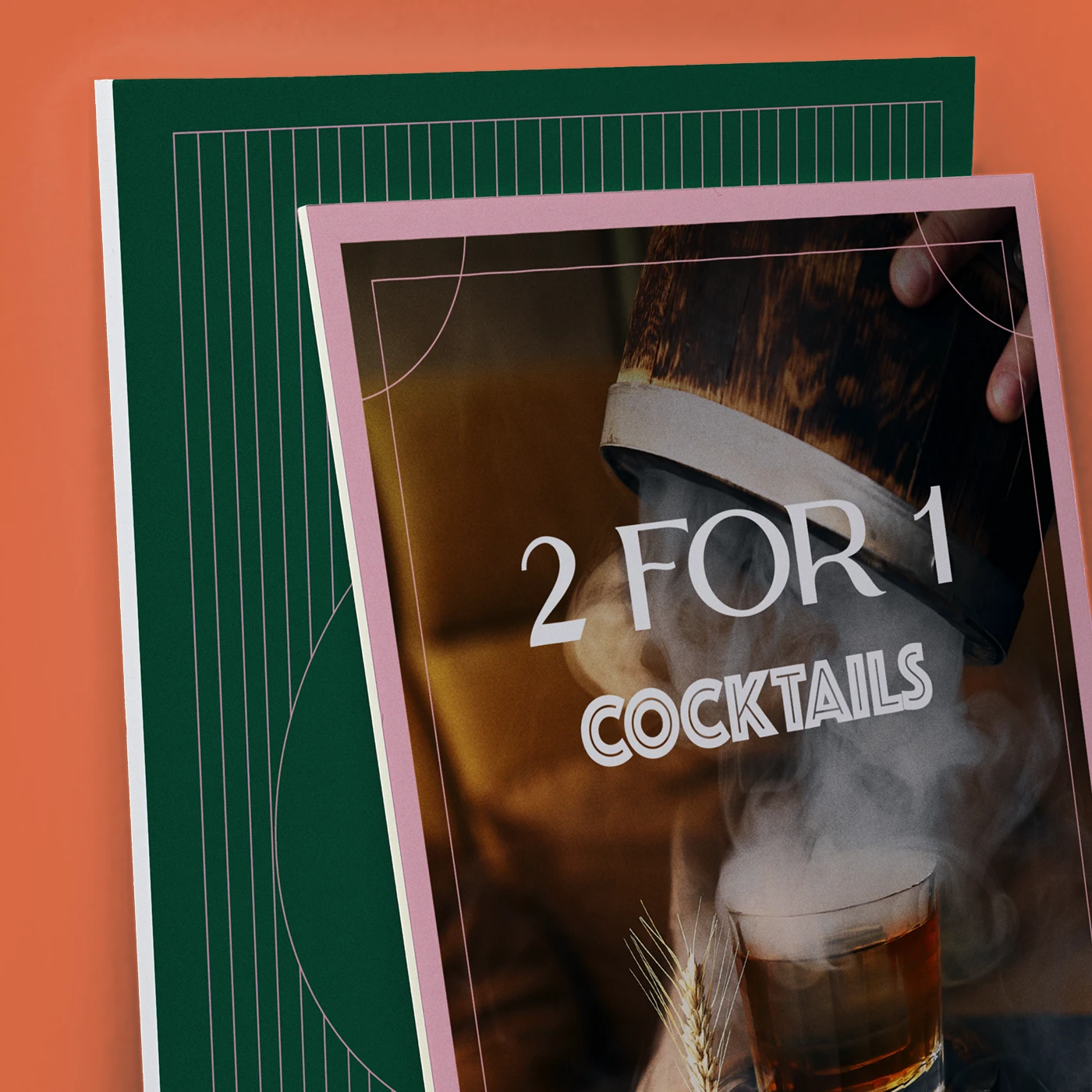 Two overlapping promotional foam boards are shown against a solid orange-terracotta background. The front board has a pink frame and features a photograph of a steaming cocktail with the text "2 FOR 1 COCKTAILS" in white. The board behind it is dark green with a pattern of thin pink vertical lines and a partial pink circular outline.