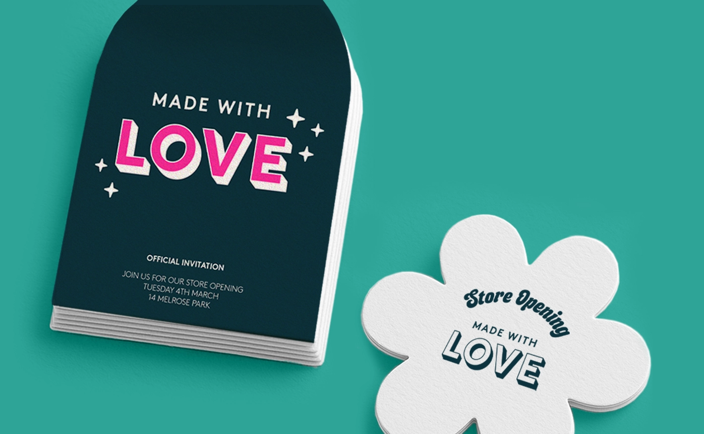 Custom-shaped marketing materials on a teal background. On the left is a stack of arch-shaped cards printed with "MADE WITH LOVE Store Opening." On the right is a single card cut into a flower shape with the same text.