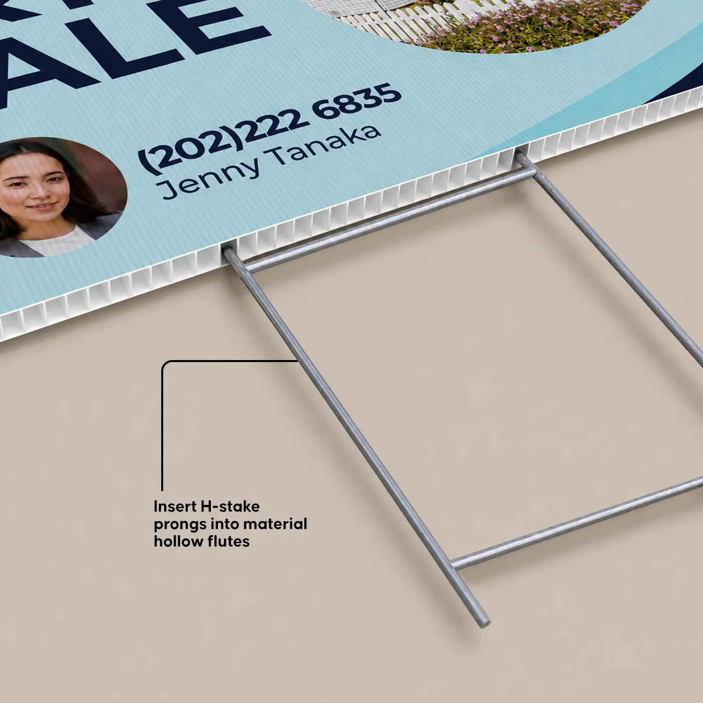A close-up view shows the metal prongs of an H-stake being inserted directly into the hollow flutes along the bottom edge of a corrugated plastic yard sign.